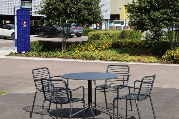 unity campus cambridge contour dining arm chair vine dining table round portrait 1
